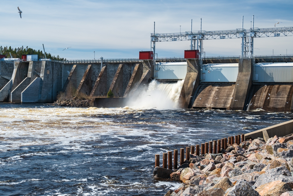 A hydropower plant releases excess water and seagulls search for food in the flowing water, image from the Ljusne strömmar power plant in Söderhamn municipality, Gavleborg county Sweden.